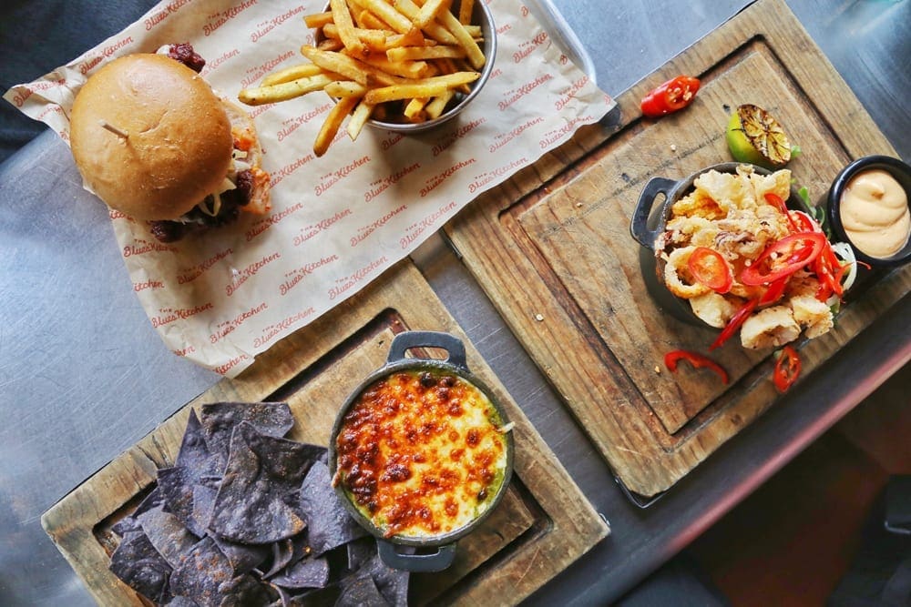 A shot taken from above of food including a burger and fries at The Blues Kitchen restaurant, Camden