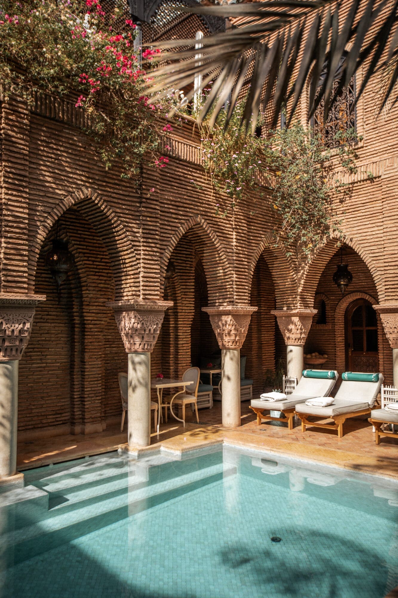 La Sultana Marrakech Review Pool Area through arches Luxury Hotels in Marrakesh