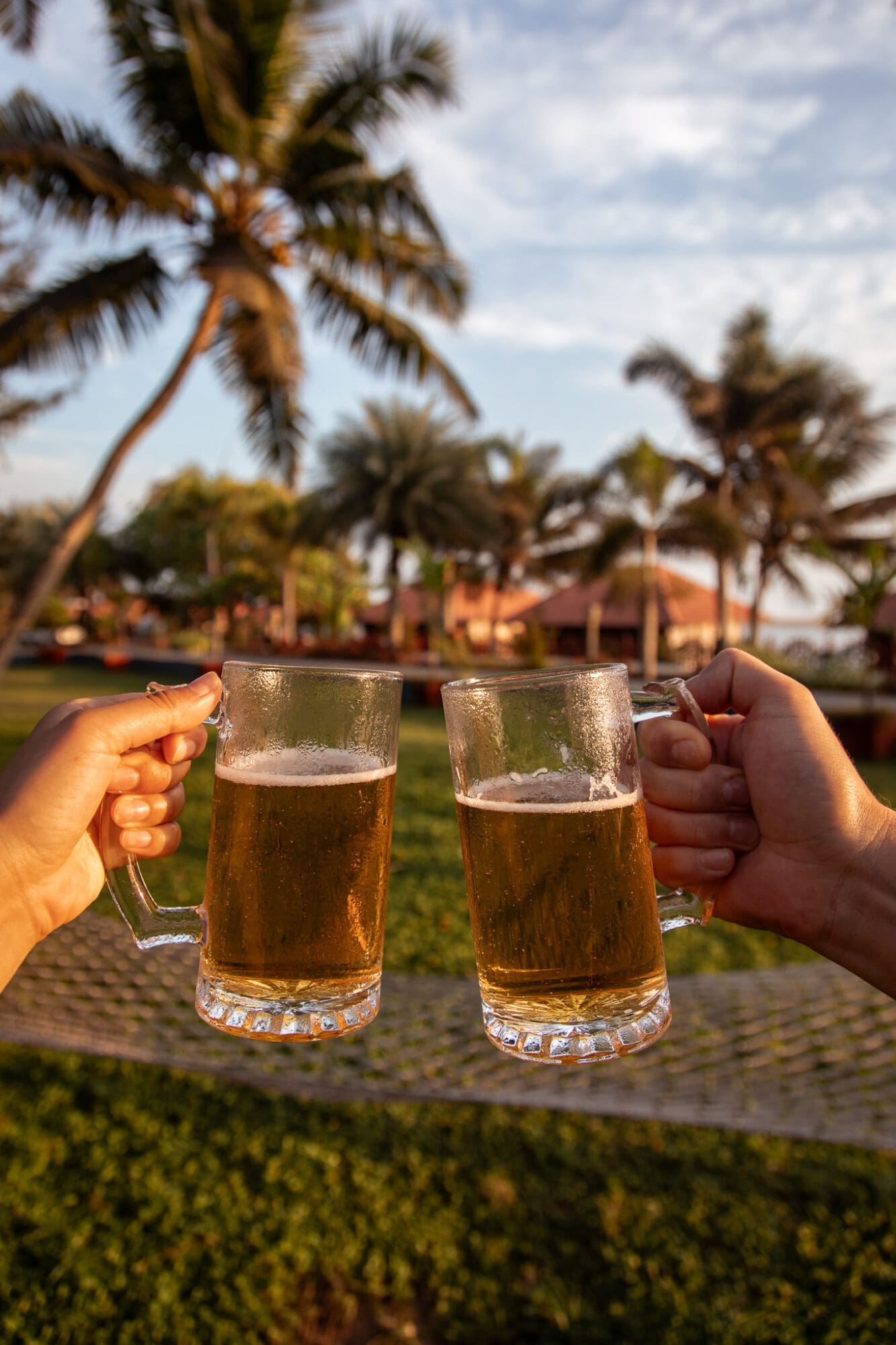 Beers at the sunset bar overlooking floating cottages at Poovar Island Resort Kerala