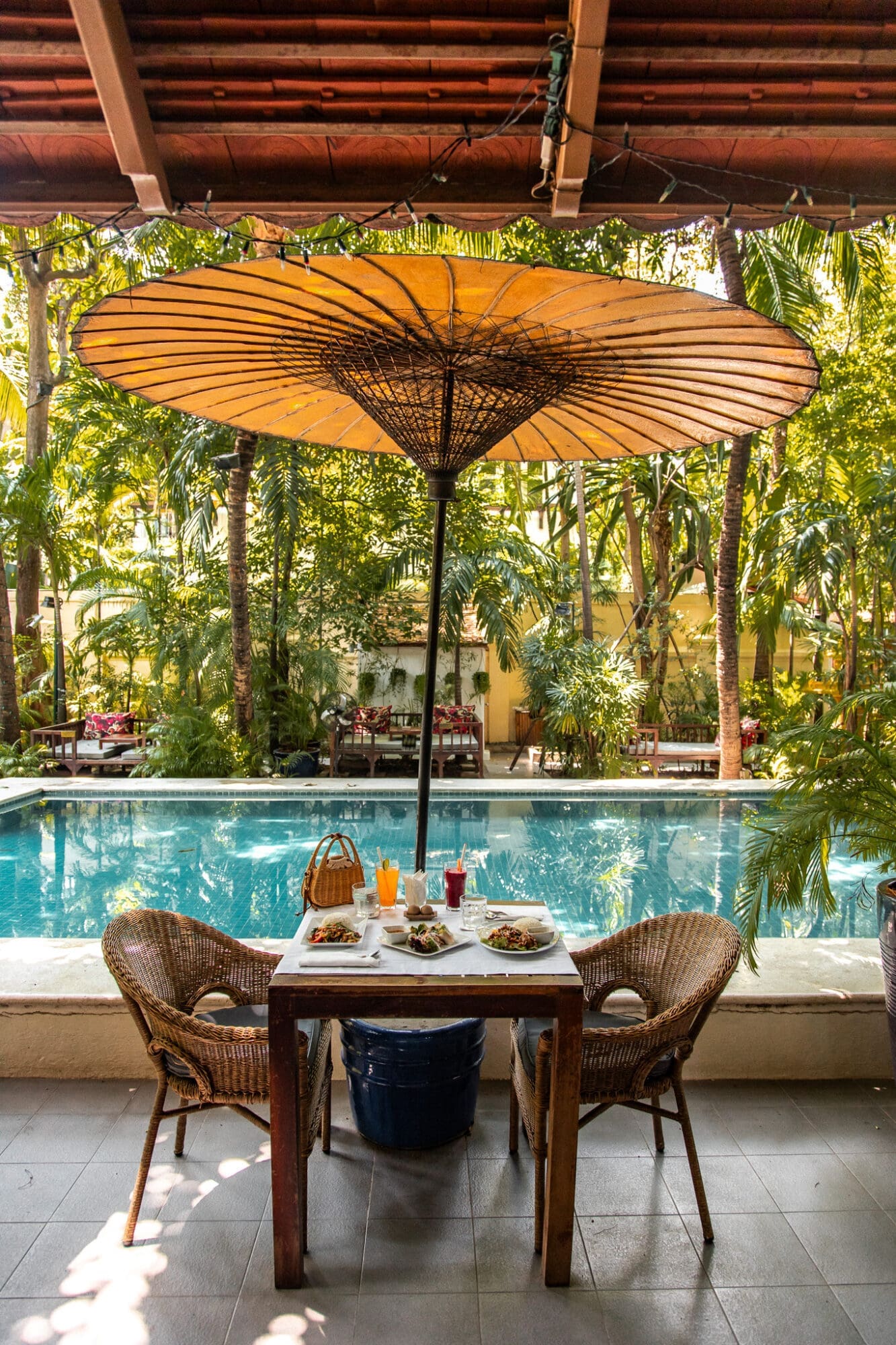 Lunch by the pool at The Pavilion Phnom Penh under an umbrella