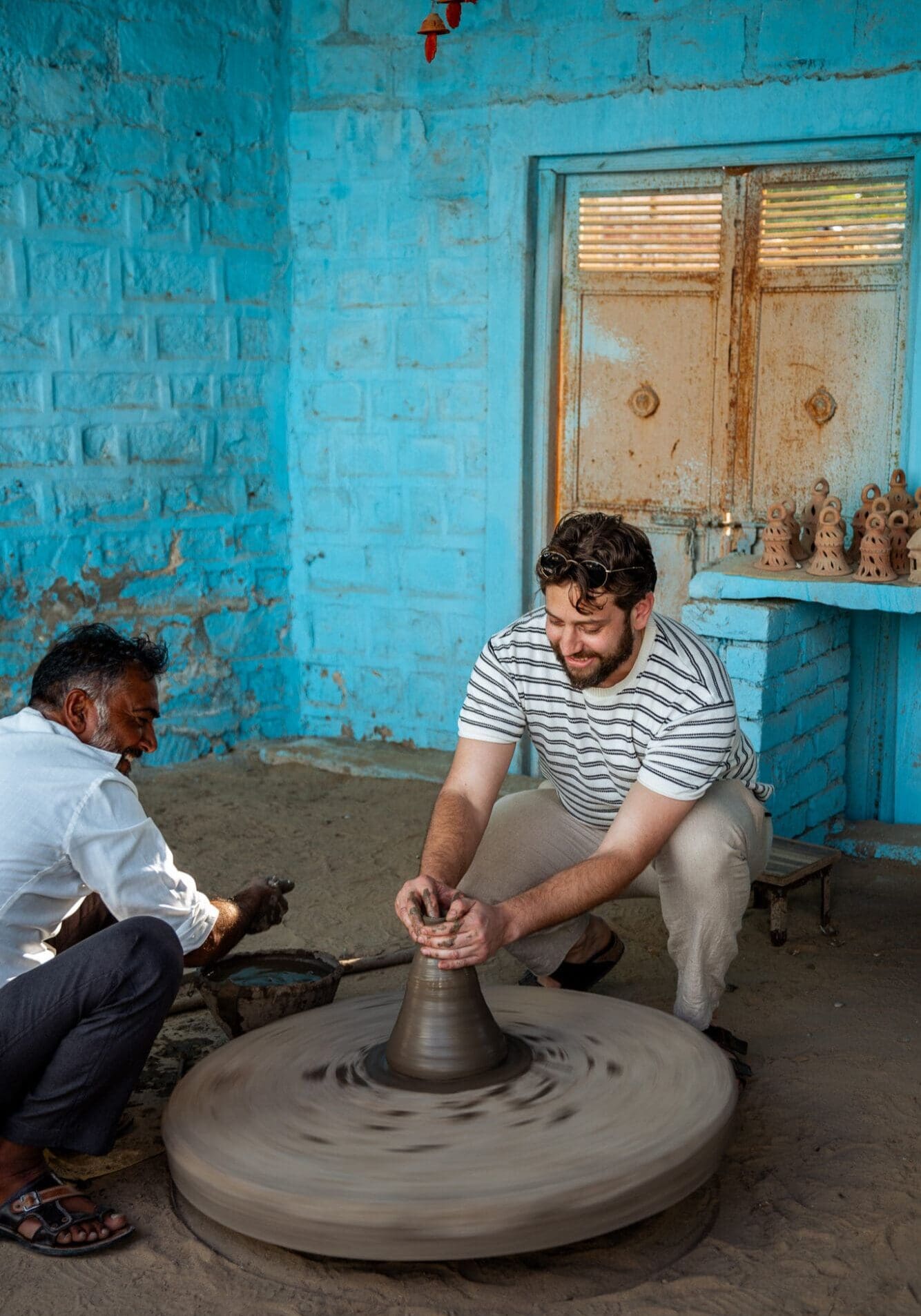 Adam trying his hand at Pottery on a village safari excursion in Rajasthan India