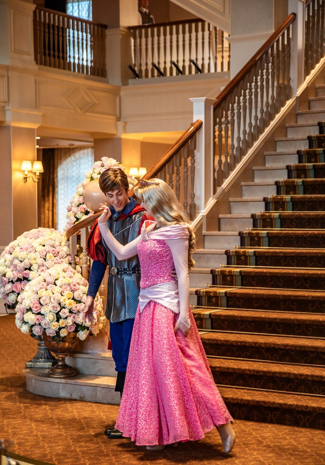 Sleeping Beauty and Prince Charming standing together at the bottom of the stairs at Disneyland Hotel Paris